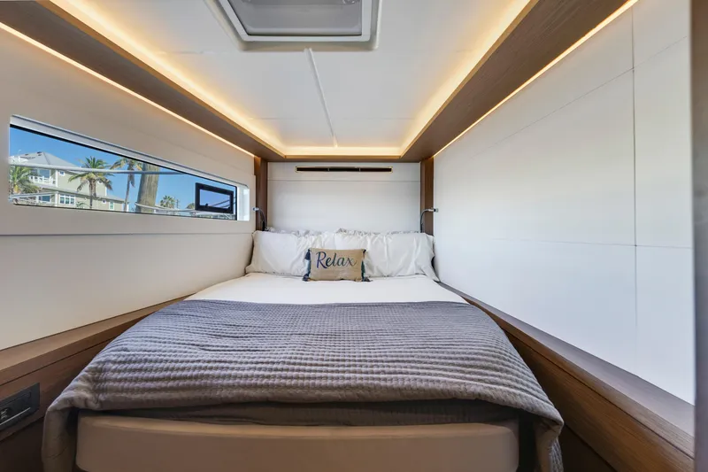 Slide: The Image of Luxurious cabin interior of 2022 Lagoon 46 yacht with cozy bed and modern lighting. - 26