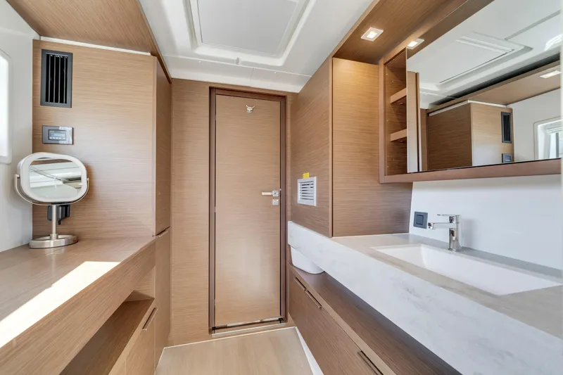 Slide: The Image of Luxurious interior of 2022 Lagoon 46 yacht bathroom with modern wood finish and sleek fixtures. - 30