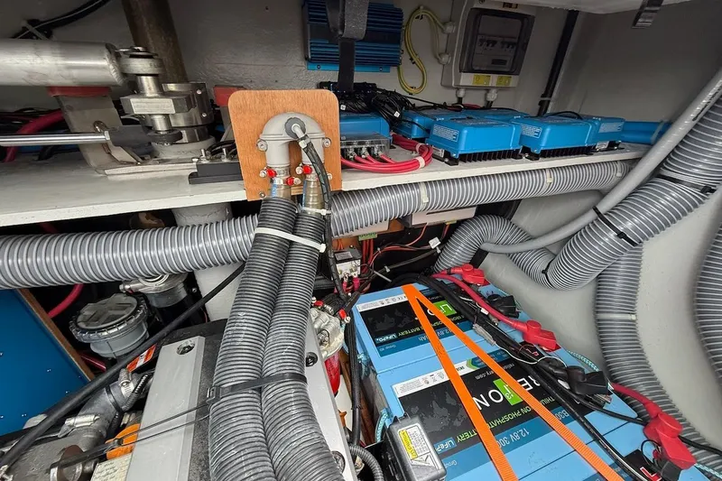 Slide: The Image of Electrical system inside a 2022 Lagoon 46 yacht, featuring batteries and wiring components. - 36