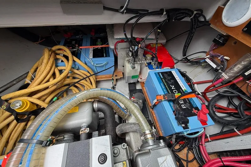 Slide: The Image of Engine compartment of a 2022 Lagoon 46 yacht with batteries and cables. - 38