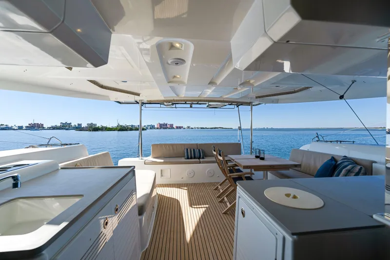 Slide: The Image of Luxurious Lagoon 46 catamaran deck, 2022 model, featuring elegant seating and ocean views. - 4