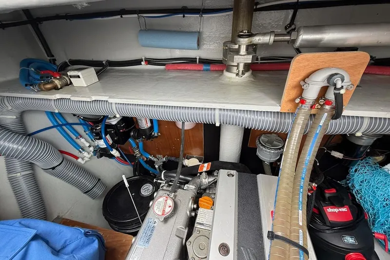 Slide: The Image of Engine room of a 2022 Lagoon 46 catamaran with visible hoses and equipment. - 40