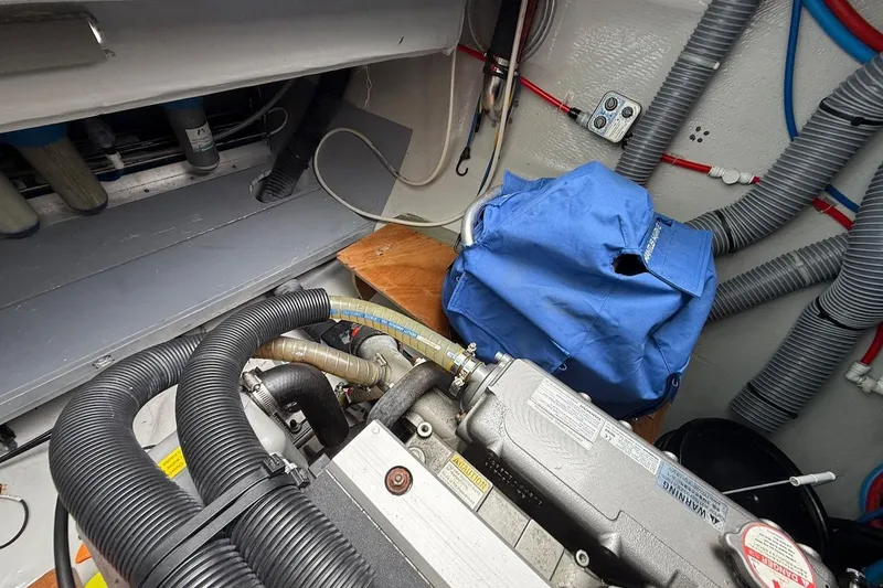 Slide: The Image of Engine room of a 2022 Lagoon 46 yacht with visible hoses and equipment. - 42
