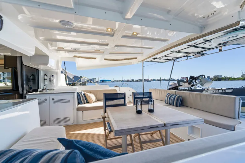 Slide: The Image of Luxurious 2022 Lagoon 46 yacht interior with elegant seating and dining area overlooking the water. - 6
