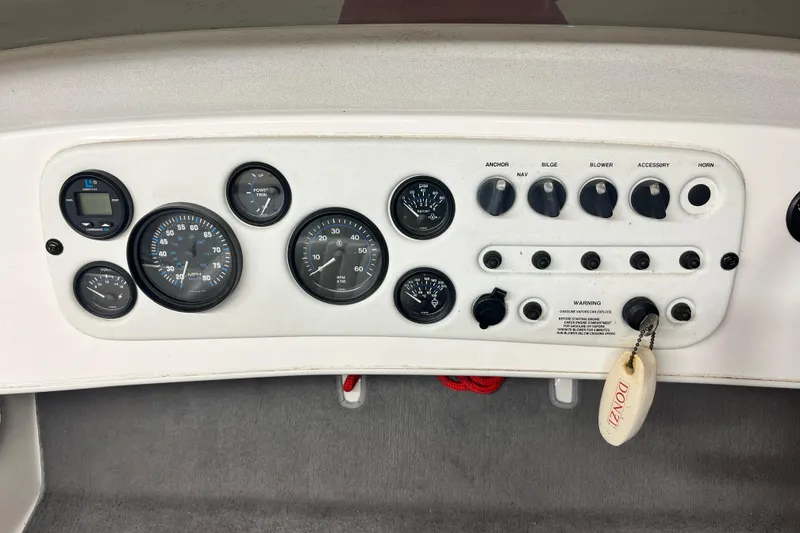 Slide: The Image of Dashboard of a 1996 Donzi 22 Classic boat with gauges and controls. - 11