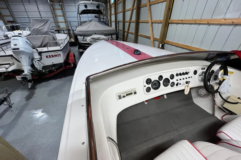 Slide: The Image of 1996 Donzi 22 Classic boat interior in storage, featuring dashboard and steering wheel. - 3