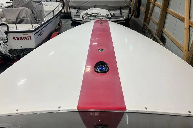Slide: The Image of 1996 Donzi 22 Classic boat with red stripe, stored indoors. - 4