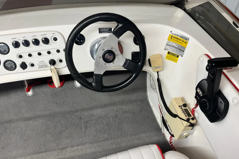 Slide: The Image of Interior dashboard of a 1996 Donzi 22 Classic boat with steering wheel and controls. - 8