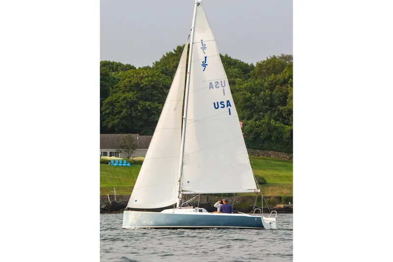Slide: The Image of 2026 J Boats J/7 sailboat on calm water near green shoreline. - 11