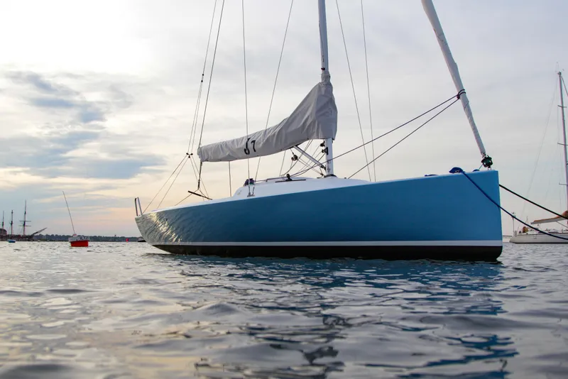 Slide: The Image of 2026 J Boats J/7 sailboat on calm water at sunset. - 13