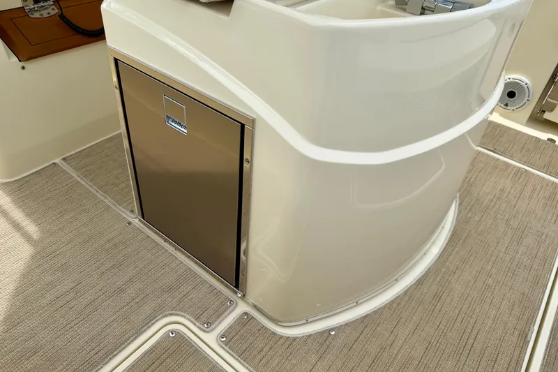 Slide: The Image of 2024 Chris-Craft Catalina 30 interior with stainless steel cabinet and beige flooring. - 12