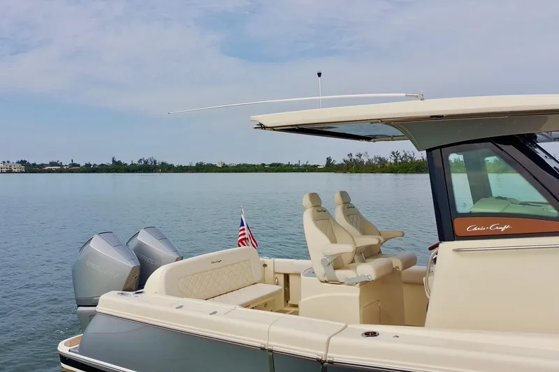 Slide: The Image of 2024 Chris-Craft Catalina 30 boat on calm water with dual Mercury engines. - 14