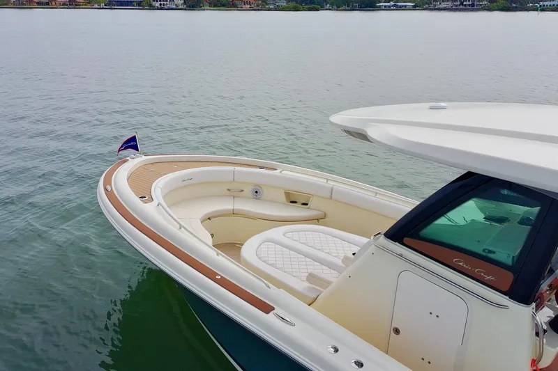 Slide: The Image of 2024 Chris-Craft Catalina 30 boat on calm water, featuring elegant seating and sleek design. - 15