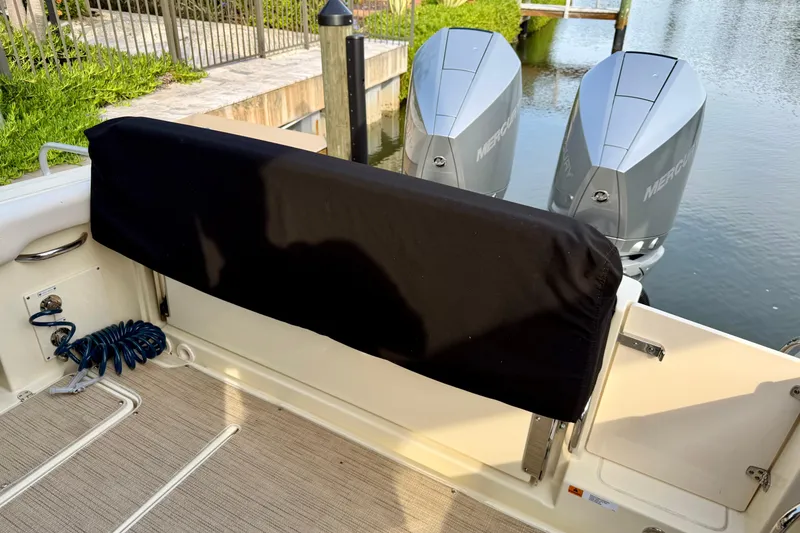 Slide: The Image of 2024 Chris-Craft Catalina 30 boat with dual Mercury engines docked by the water. - 17