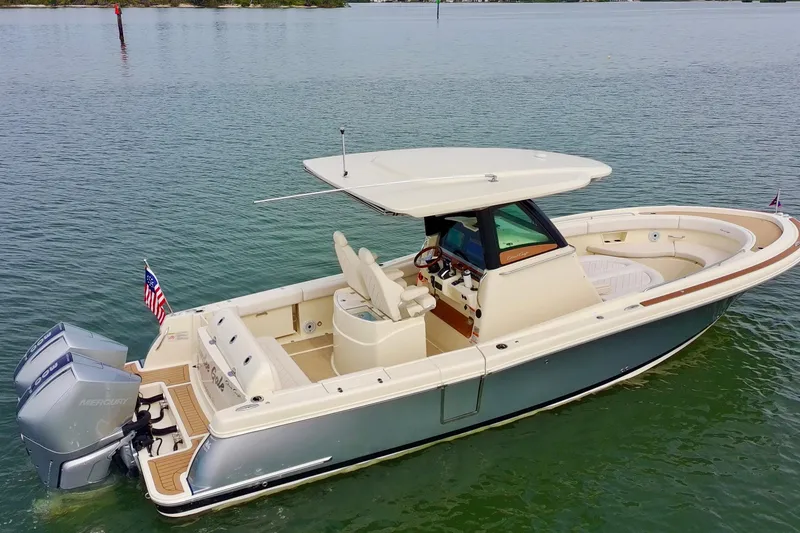 Slide: The Image of 2024 Chris-Craft Catalina 30 boat on calm water, featuring sleek design and dual Mercury engines. - 3