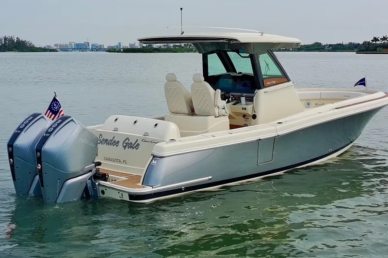 Slide: The Image of 2024 Chris-Craft Catalina 30 boat on water, featuring dual Mercury engines. - 30
