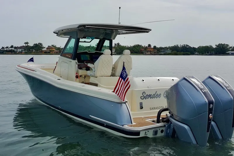 Slide: The Image of 2024 Chris-Craft Catalina 30 boat on water, featuring dual engines and American flag. - 31