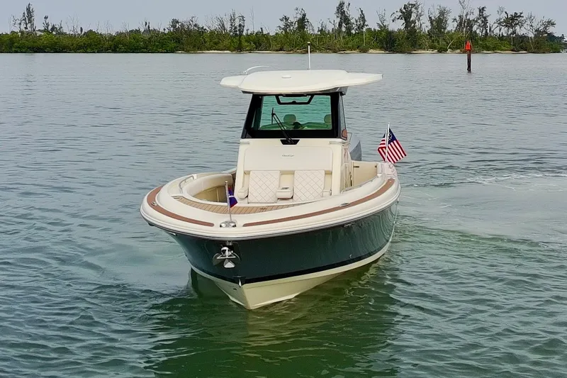Slide: The Image of 2024 Chris-Craft Catalina 30 boat cruising on calm waters with American flag. - 38