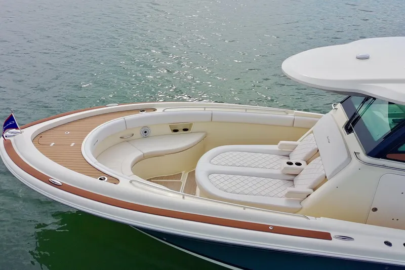 Slide: The Image of 2024 Chris-Craft Catalina 30 boat with elegant seating and teak deck on calm water. - 5