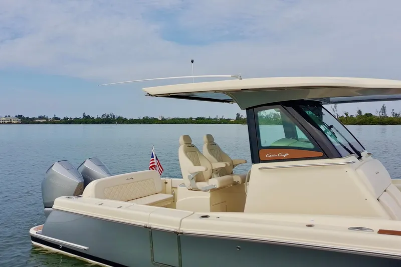 Slide: The Image of 2024 Chris-Craft Catalina 30 boat on calm water, featuring elegant design and twin engines. - 6