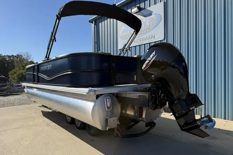 Slide: The Image of 2026 Premier 220 Sunscape RF XLC pontoon boat with Mercury outboard motor, docked outdoors. - 1