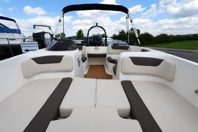 Slide: The Image of 2019 Bayliner Element 160 boat with spacious seating and sleek design under a blue sky. - 11