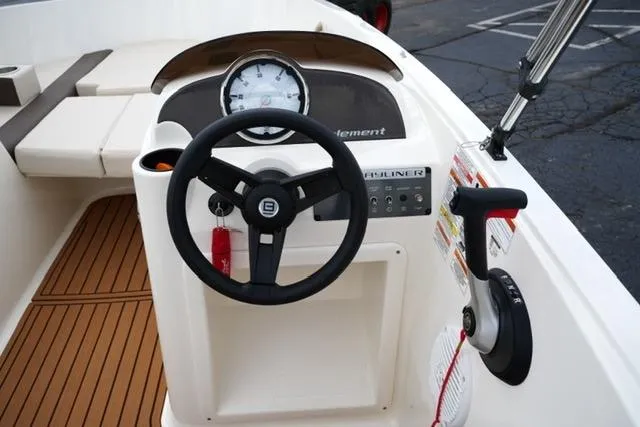 Slide: The Image of 2019 Bayliner Element 160 boat dashboard with steering wheel and controls. - 13