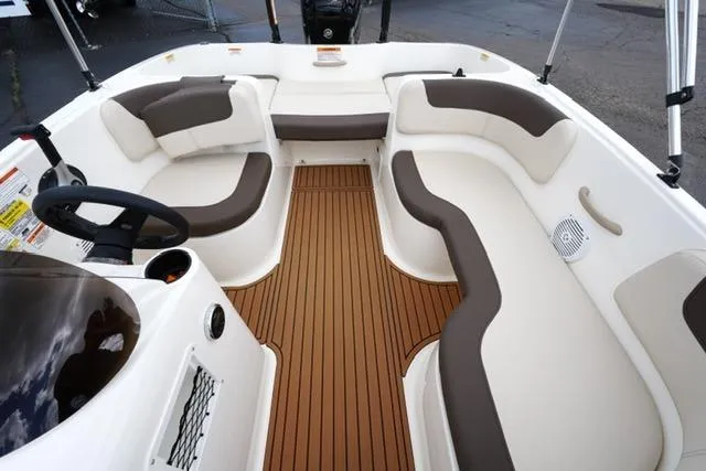 Slide: The Image of 2019 Bayliner Element 160 boat interior with cushioned seating and wood-style flooring. - 14