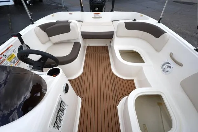 Slide: The Image of 2019 Bayliner Element 160 boat interior with seating and storage compartments. - 15