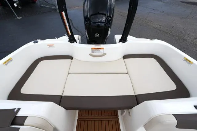 Slide: The Image of 2019 Bayliner Element 160 boat interior with cushioned seating and outboard motor. - 16