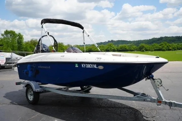 Slide: The Image of 2019 Bayliner Element 160 boat on trailer, parked outdoors under a cloudy sky. - 3