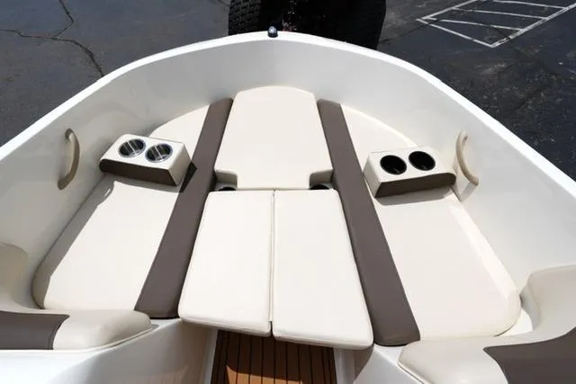 Slide: The Image of 2019 Bayliner Element 160 boat interior with cushioned seating and cup holders. - 9