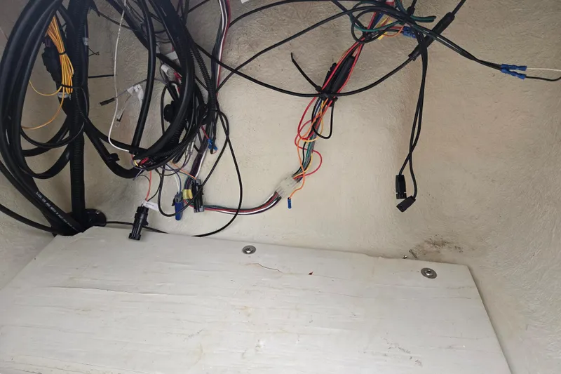 Slide: The Image of Tangled wiring inside a 2004 Odyssey Pontoons 2302 Millennium boat compartment. - 14