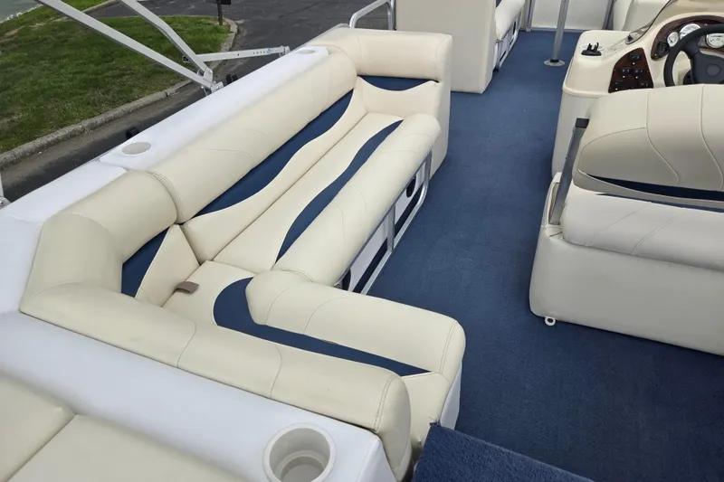 Slide: The Image of 2004 Odyssey Pontoons 2302 Millennium interior with plush seating and blue carpet. - 19