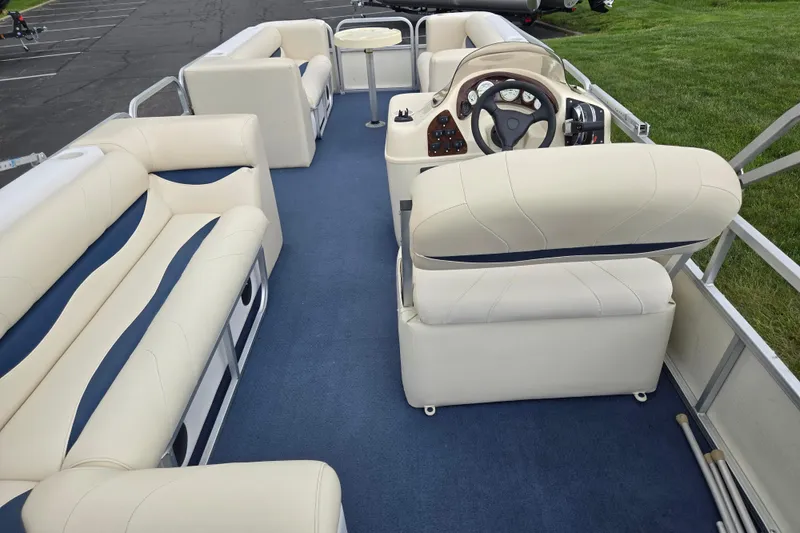 Slide: The Image of 2004 Odyssey Pontoons 2302 Millennium interior with plush seating and steering console. - 20