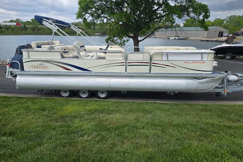 Slide: The Image of 2004 Odyssey Pontoons 2302 Millennium boat on trailer by a lakeside. - 9