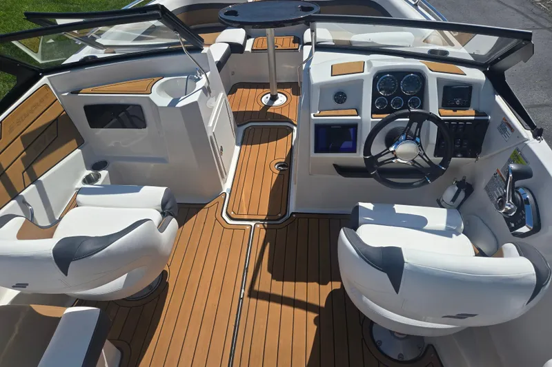 Slide: The Image of Interior of 2023 Starcraft SVX 230 IO boat with modern dashboard and seating. - 11
