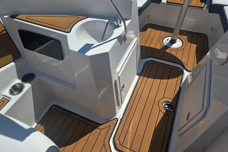 Slide: The Image of 2023 Starcraft SVX 230 IO boat interior with wood flooring and sleek design elements. - 14