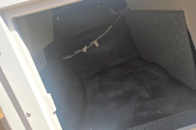 Slide: The Image of Interior compartment of 2023 Starcraft SVX 230 IO boat, showing wiring and textured surfaces. - 17