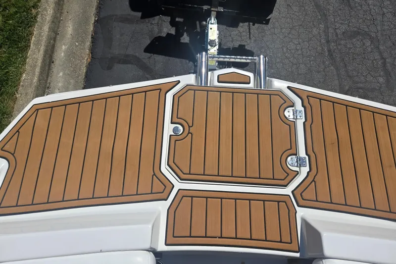 Slide: The Image of 2023 Starcraft SVX 230 IO boat with teak-style deck flooring. - 19