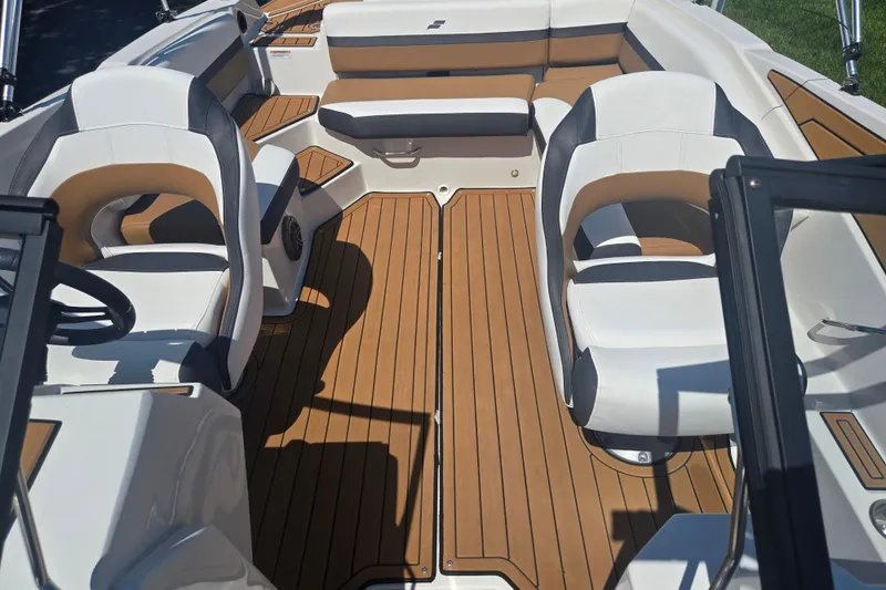 Slide: The Image of 2023 Starcraft SVX 230 IO boat interior with stylish seating and wood-like flooring. - 22
