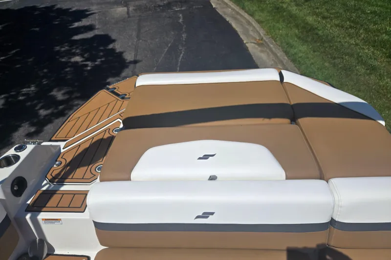 Slide: The Image of 2023 Starcraft SVX 230 IO boat with tan and white seating on a sunny day. - 24
