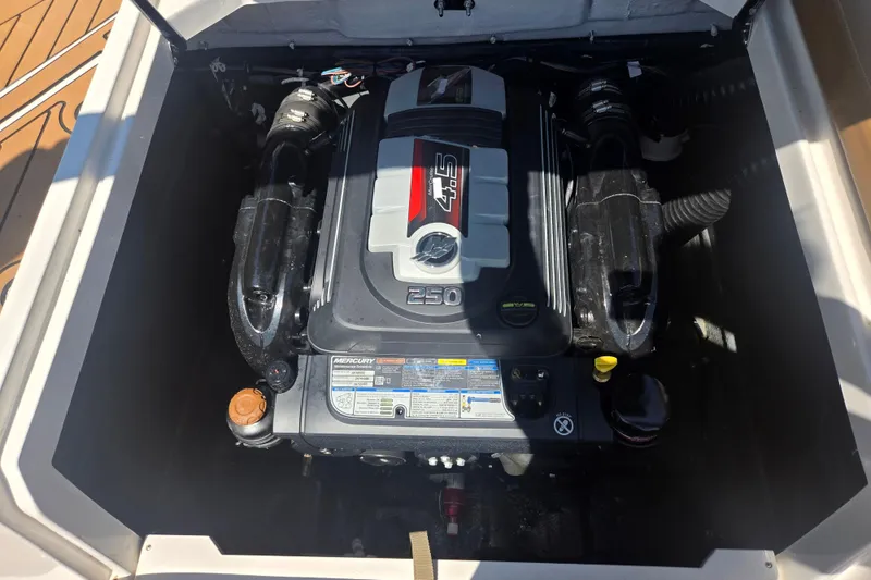 Slide: The Image of Engine compartment of 2023 Starcraft SVX 230 IO boat, featuring a Mercury 4.5L engine. - 25