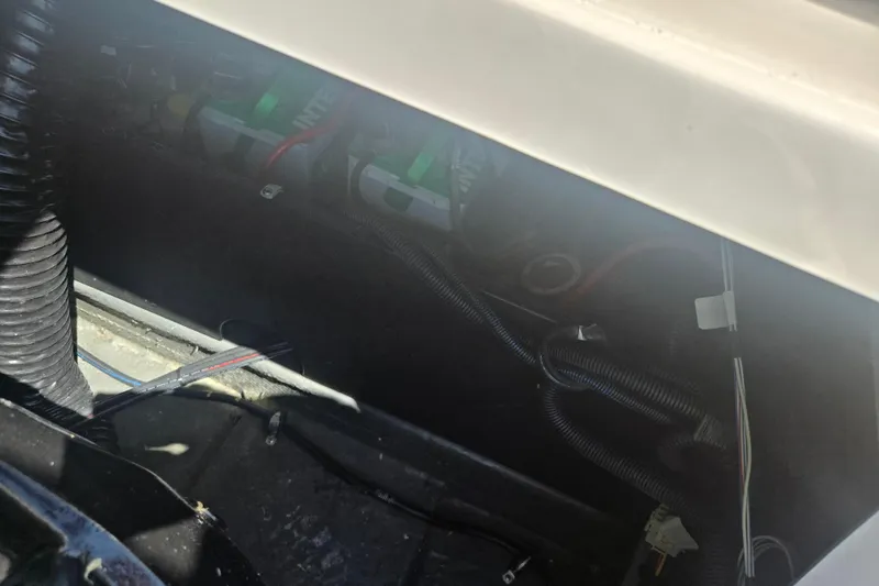 Slide: The Image of 2023 Starcraft SVX 230 IO engine compartment with visible wiring and components. - 26