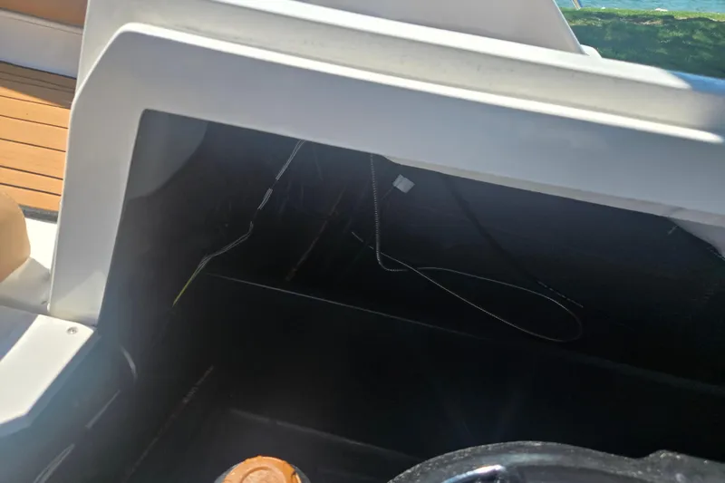 Slide: The Image of 2023 Starcraft SVX 230 IO boat interior storage compartment with visible wiring. - 27