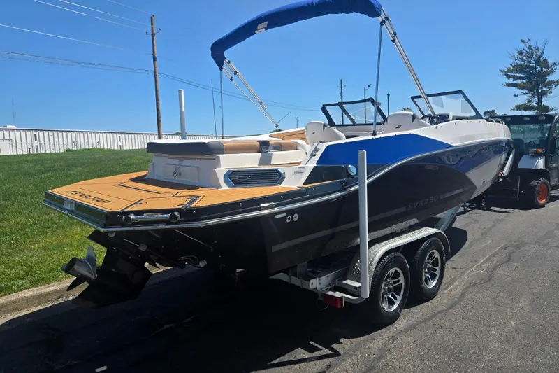 Slide: The Image of 2023 Starcraft SVX 230 IO boat on trailer, featuring sleek design and modern amenities. - 3