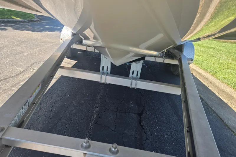 Slide: The Image of 2023 Starcraft SVX 230 IO boat on trailer, showing hull and trailer details. - 7