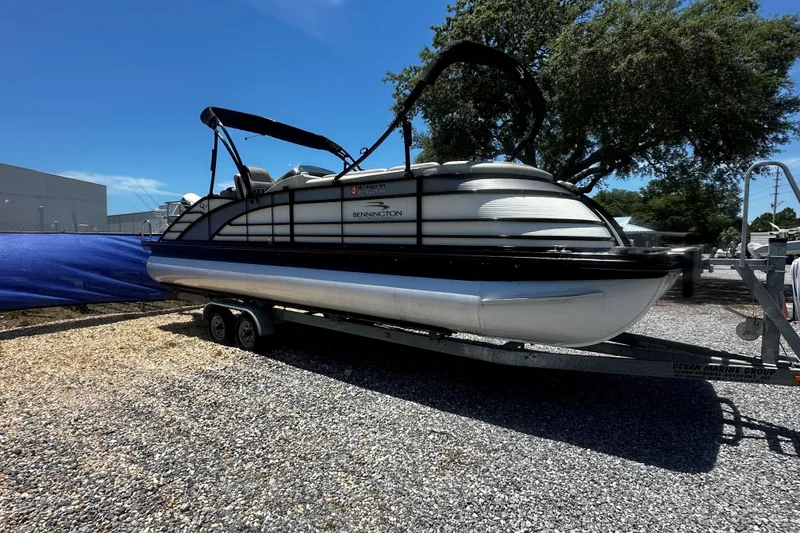 Slide: The Image of 2019 Bennington QX 25 Stern Lounge pontoon boat on trailer, parked outdoors. - 3