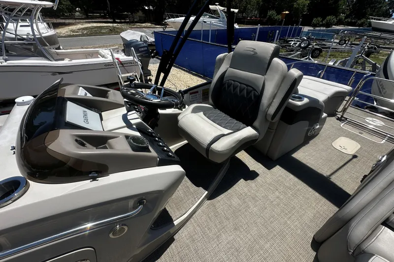 Slide: The Image of 2019 Bennington QX 25 Stern Lounge boat interior with helm and seating. - 4