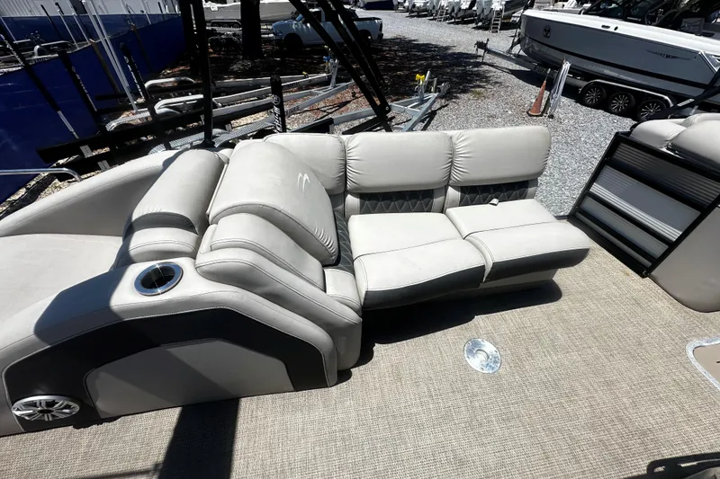 Slide: The Image of 2019 Bennington QX 25 Stern Lounge with plush seating on a boat deck. - 7
